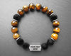 Engraved stainless steel bracelet with brown tiger eye and volcano rock beads